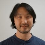 An asian man wearing a dark blue shirt