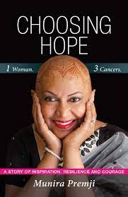 Cover for CHOOSING HOPE: ONE WOMAN THREE CANCERS by Munira Premji. Image shows a bald Indian woman resting her face in her hands and smiling against a black background.