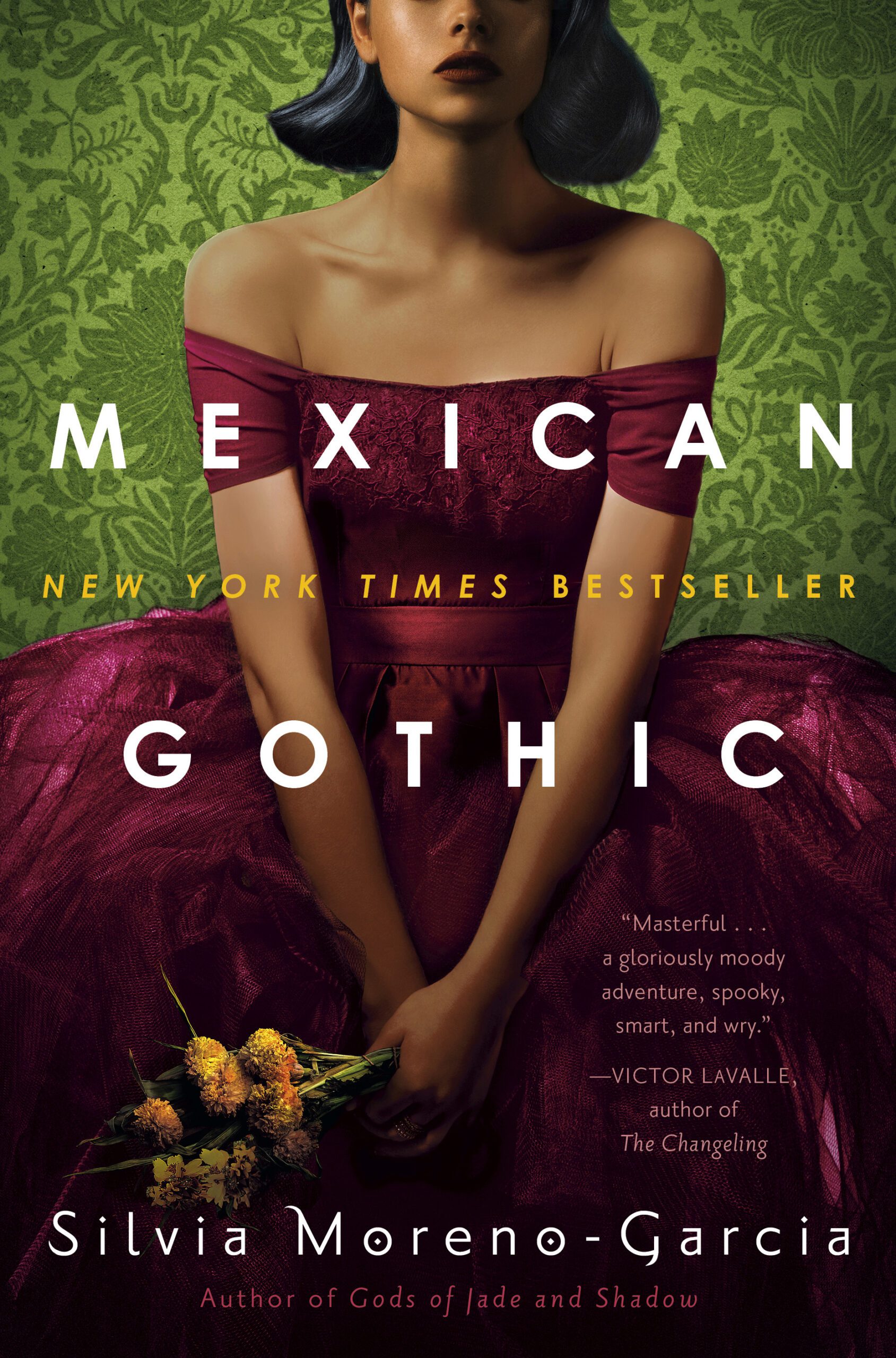 Latina woman wearing a magenta off-the-shoulder dress, against a green background, holding a bouquet of flowers. Mexican Gothic by Silvia Moreno-Garcia.