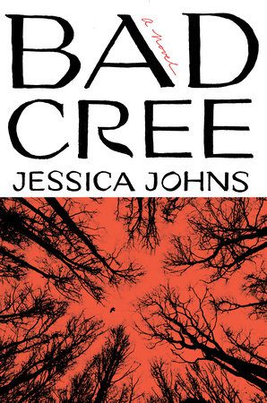 The cover of Bad Cree: A Novel by Jessica Johns. The top half features the title in large black letters on a white background, with “a novel” handwritten in red across the “A.” The bottom half shows a stark red sky framed by the dark silhouettes of bare tree branches stretching inward.
